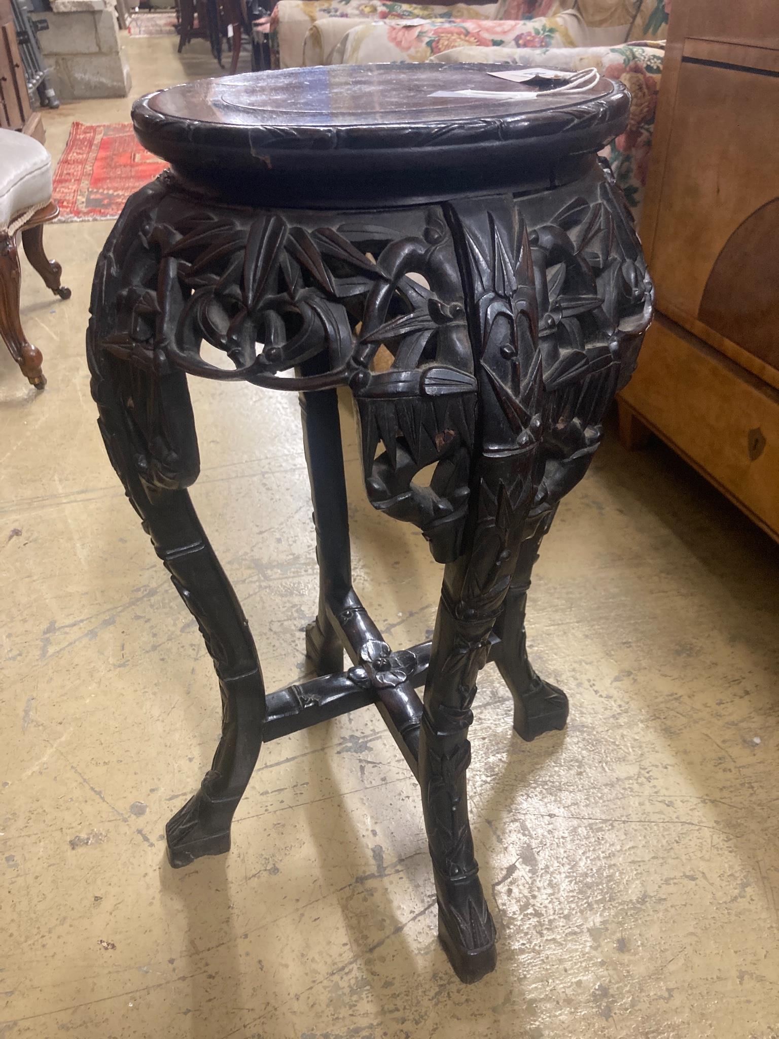 A Chinese carved hardwood marble top vase stand